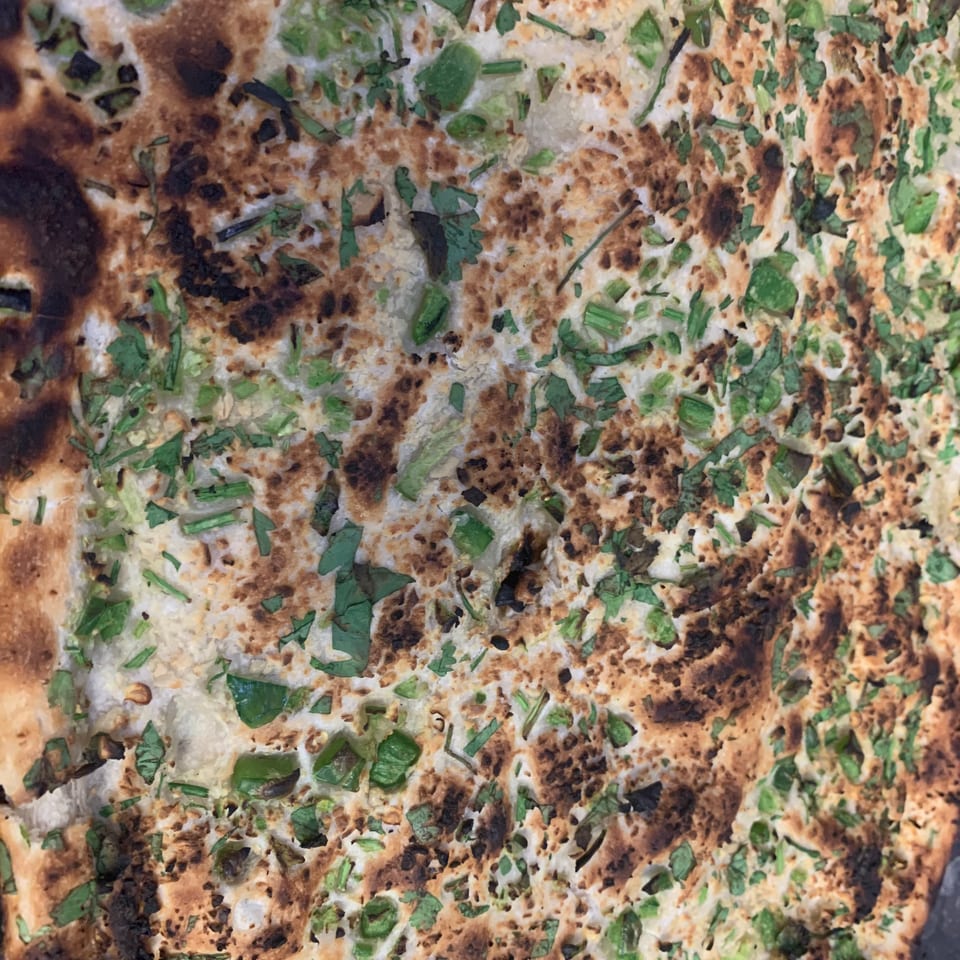 Herb-topped flatbread at Curry Corner